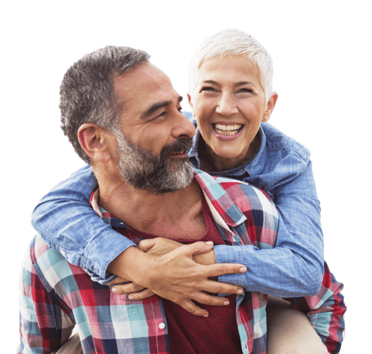 a smiling, older woman on the back on an older man.