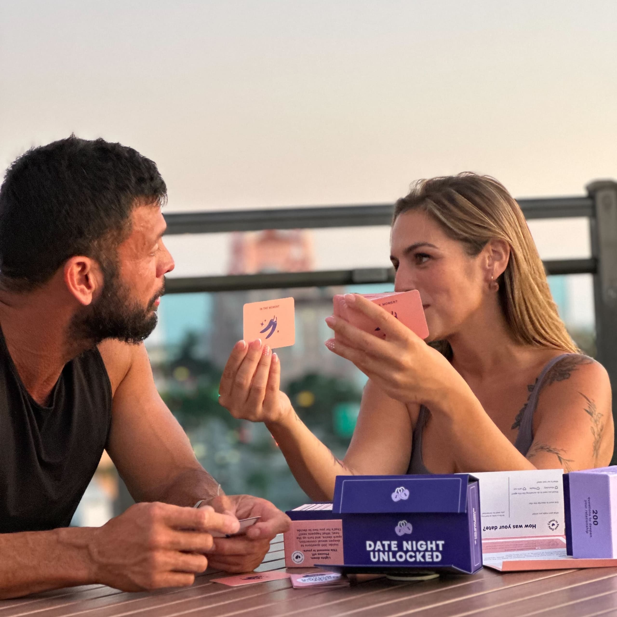 A couple playing with Paired's physical card game "Date Night Unlocked"
